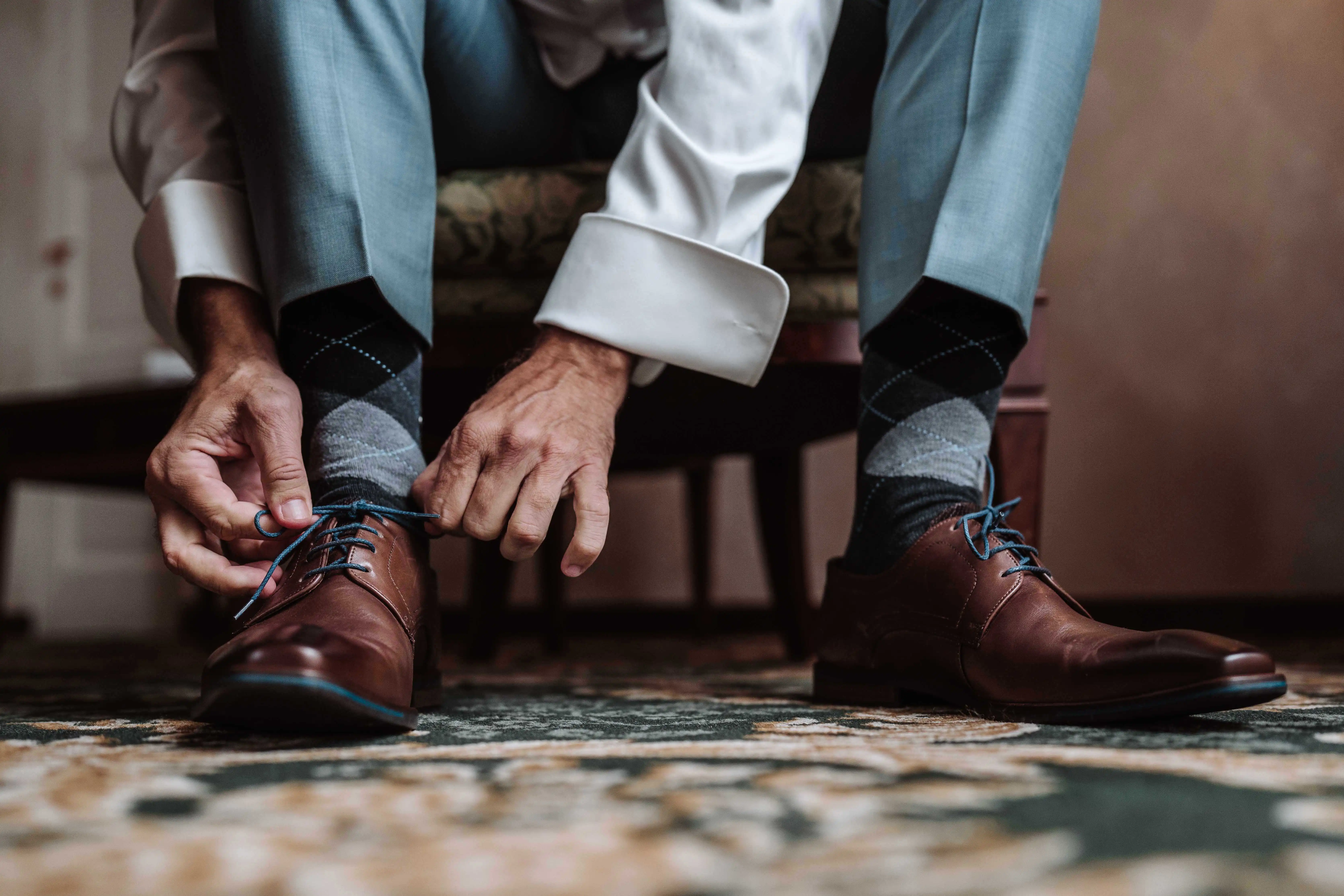 groom tying shoelaces elegant shoes wedding preparation close up