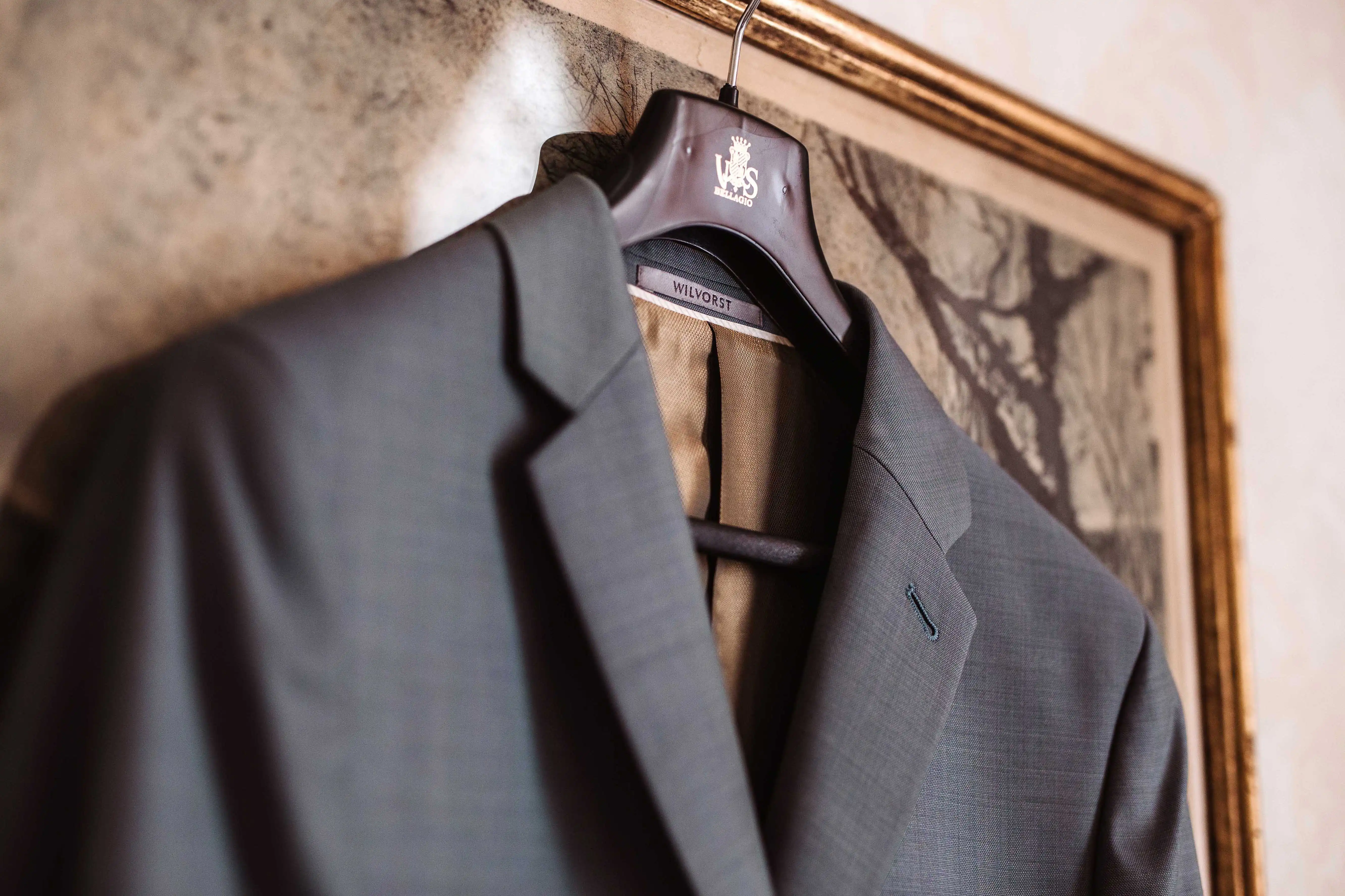 Elegant groom suit hanging in historic villa interior before wedding ceremony in Italy