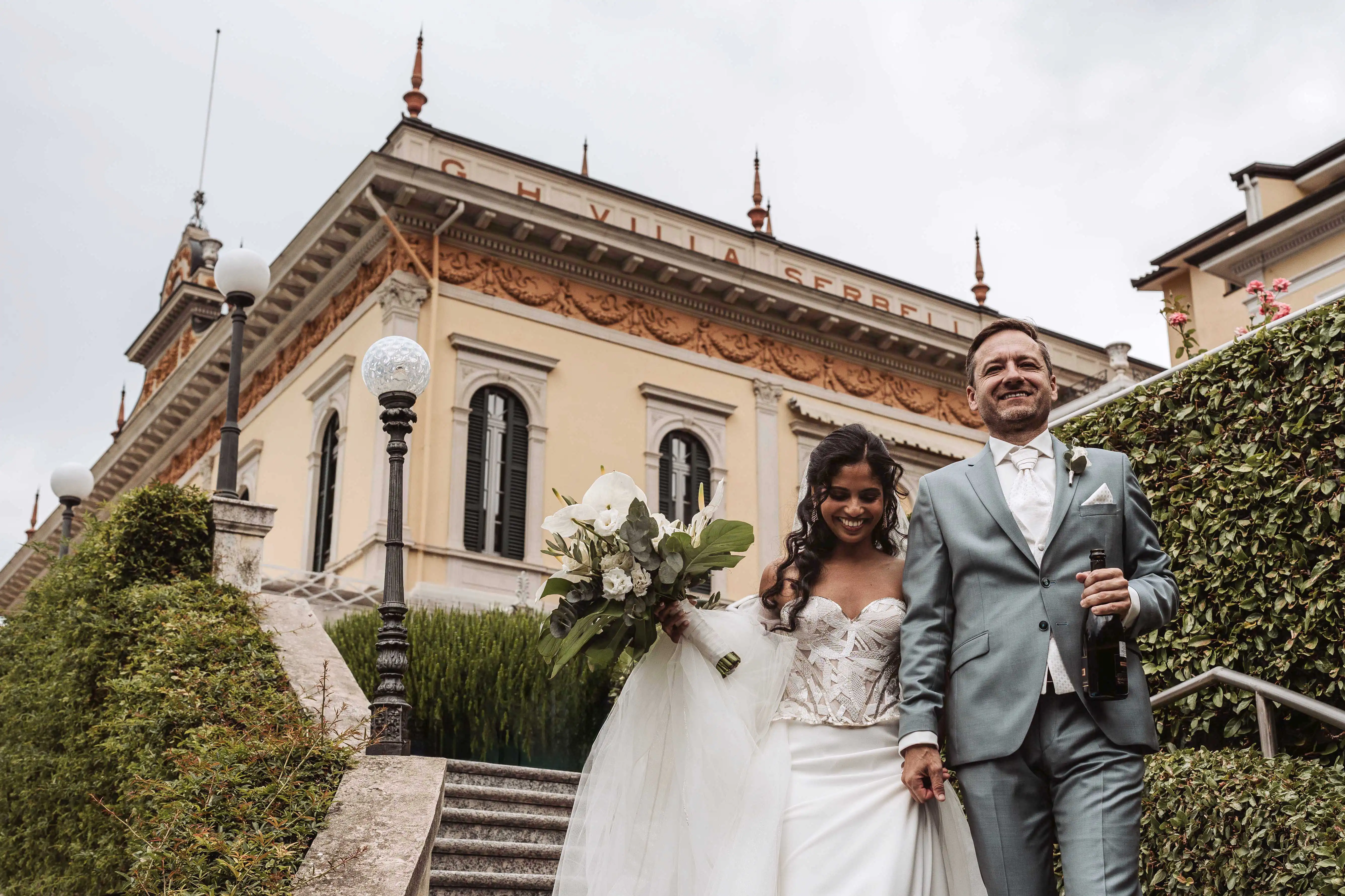 Bride and groom walking outside historic villa in Lake Como after ceremony