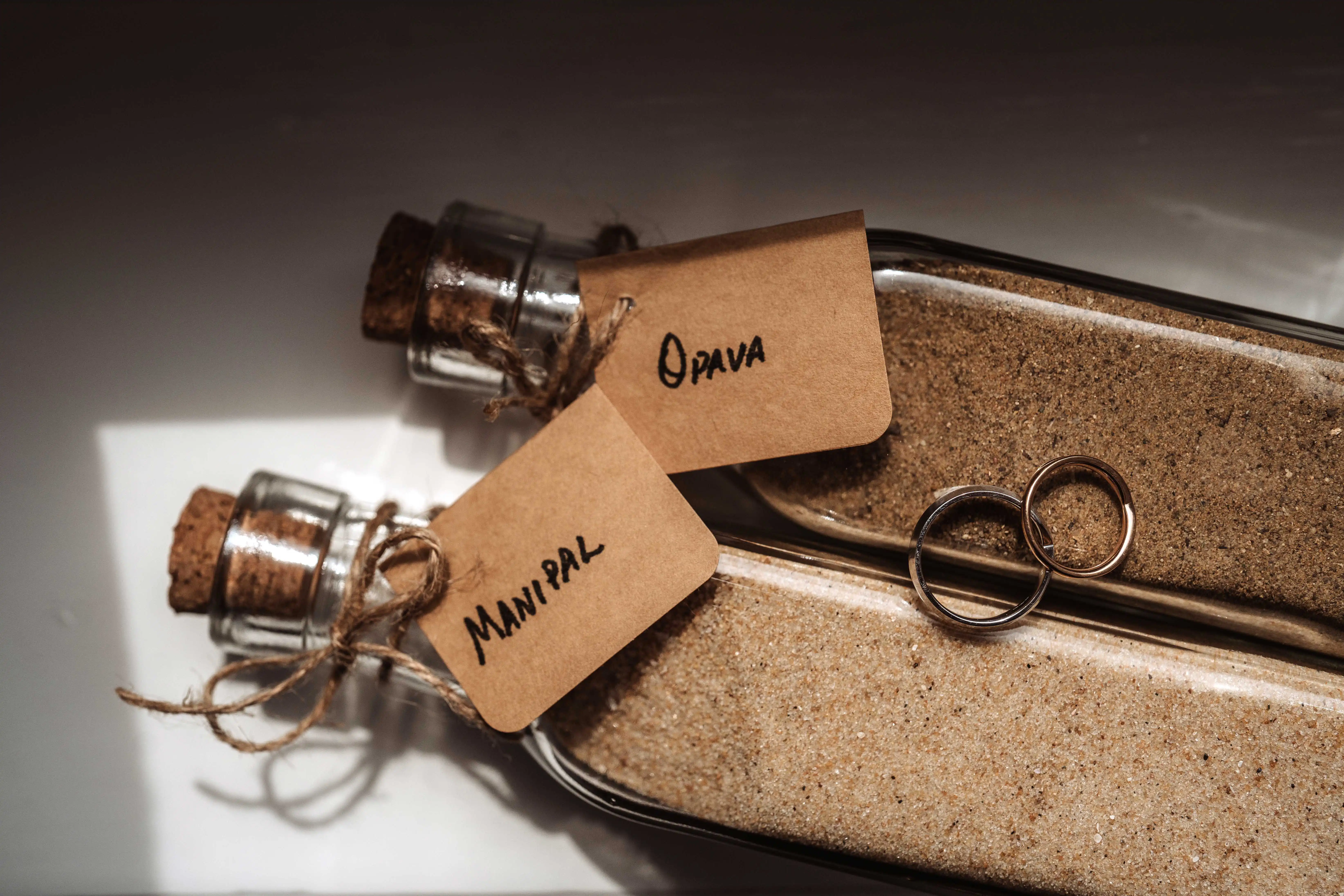 Wedding rings with sand ceremony details during intimate destination wedding in Italy