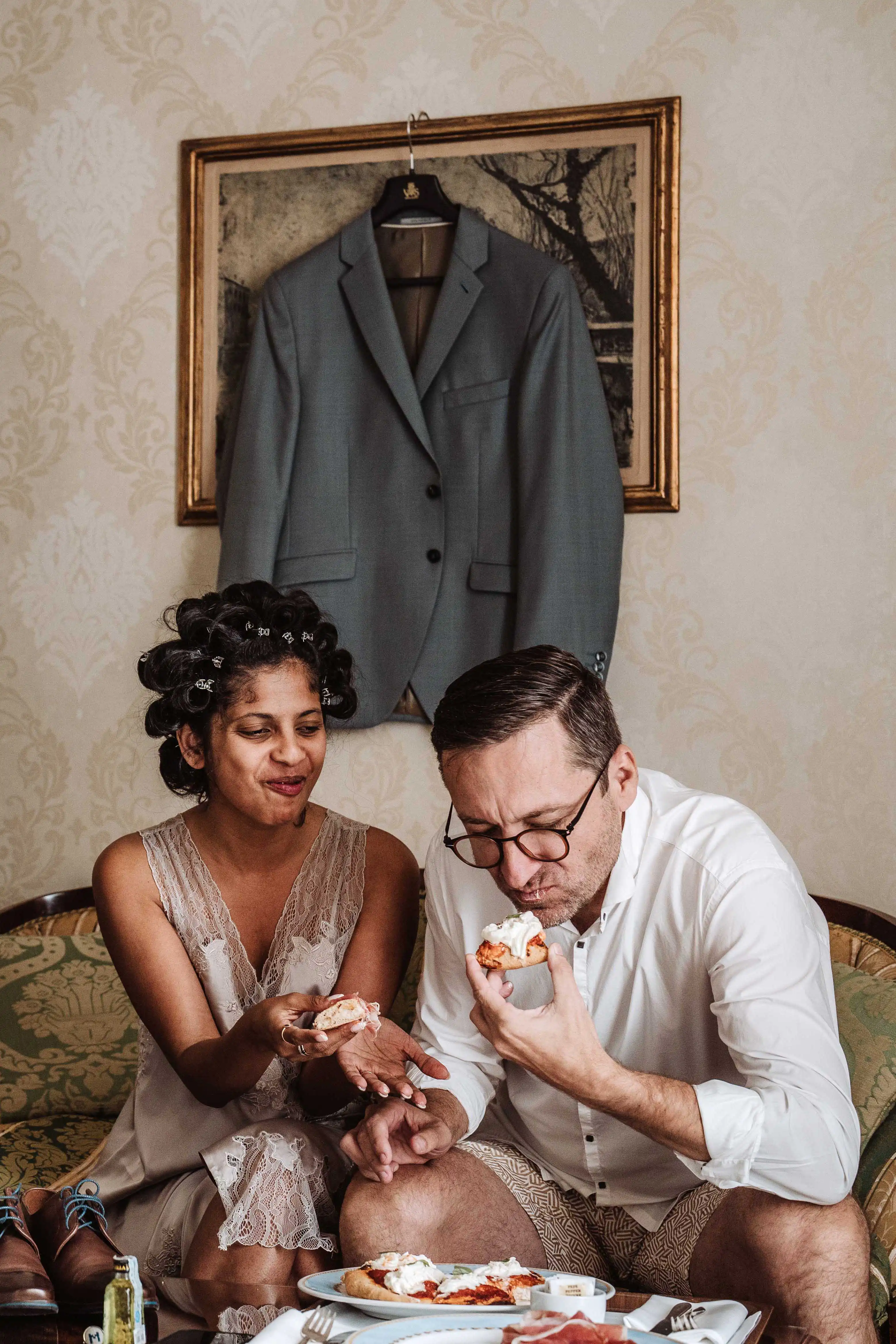 Couple sharing candid moment during wedding morning in elegant Italian villa setting