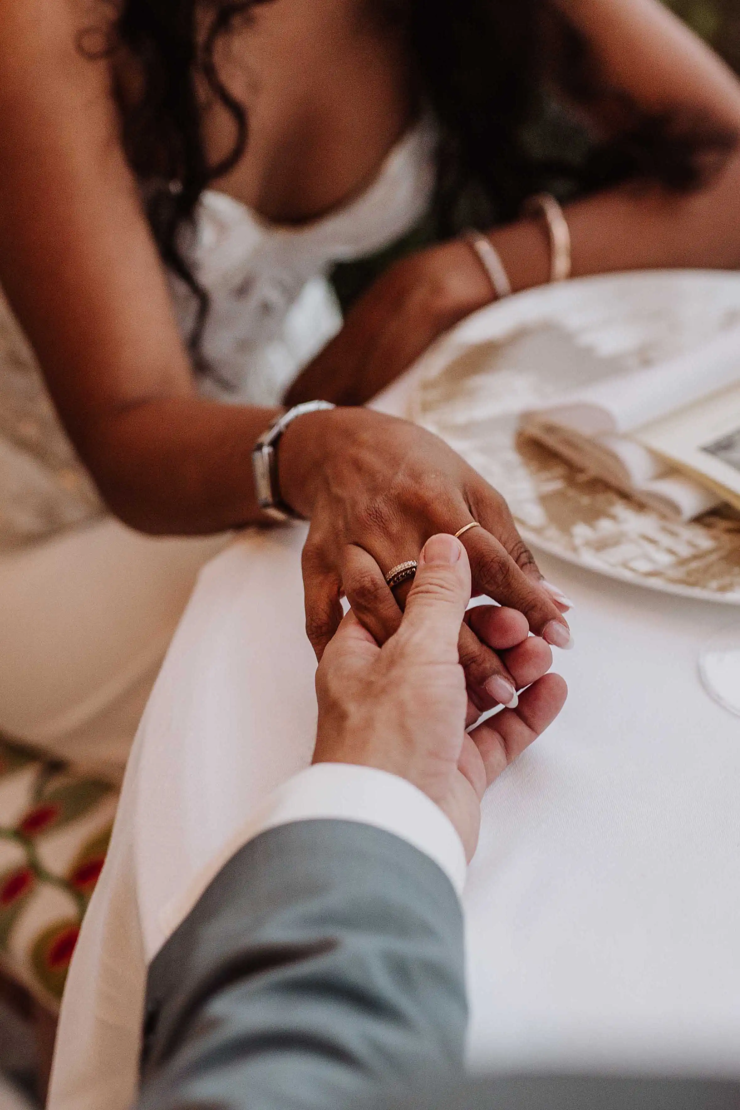 Close-up of groom holding bride’s hand showing wedding rings during an intimate Lake Como wedding moment