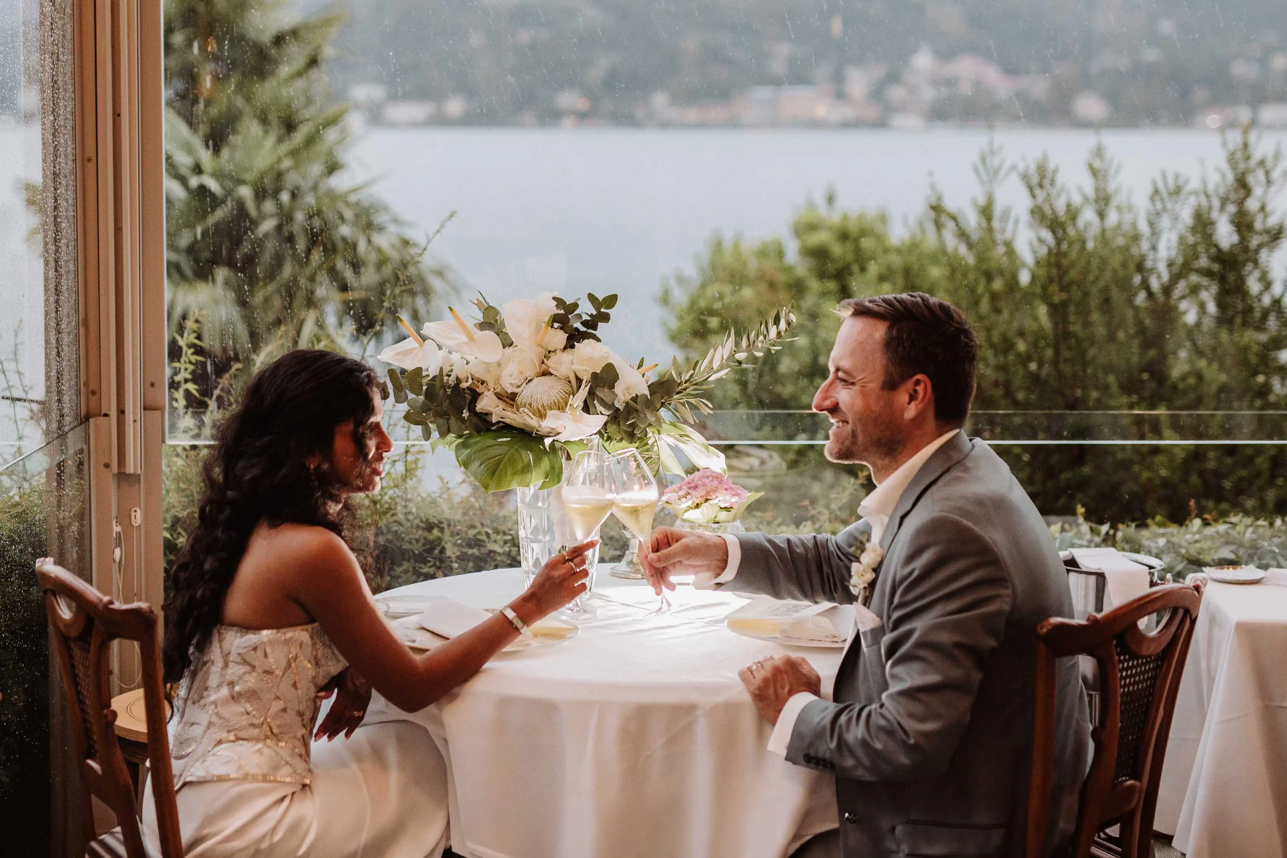 Bride and groom toasting with champagne overlooking Lake Como