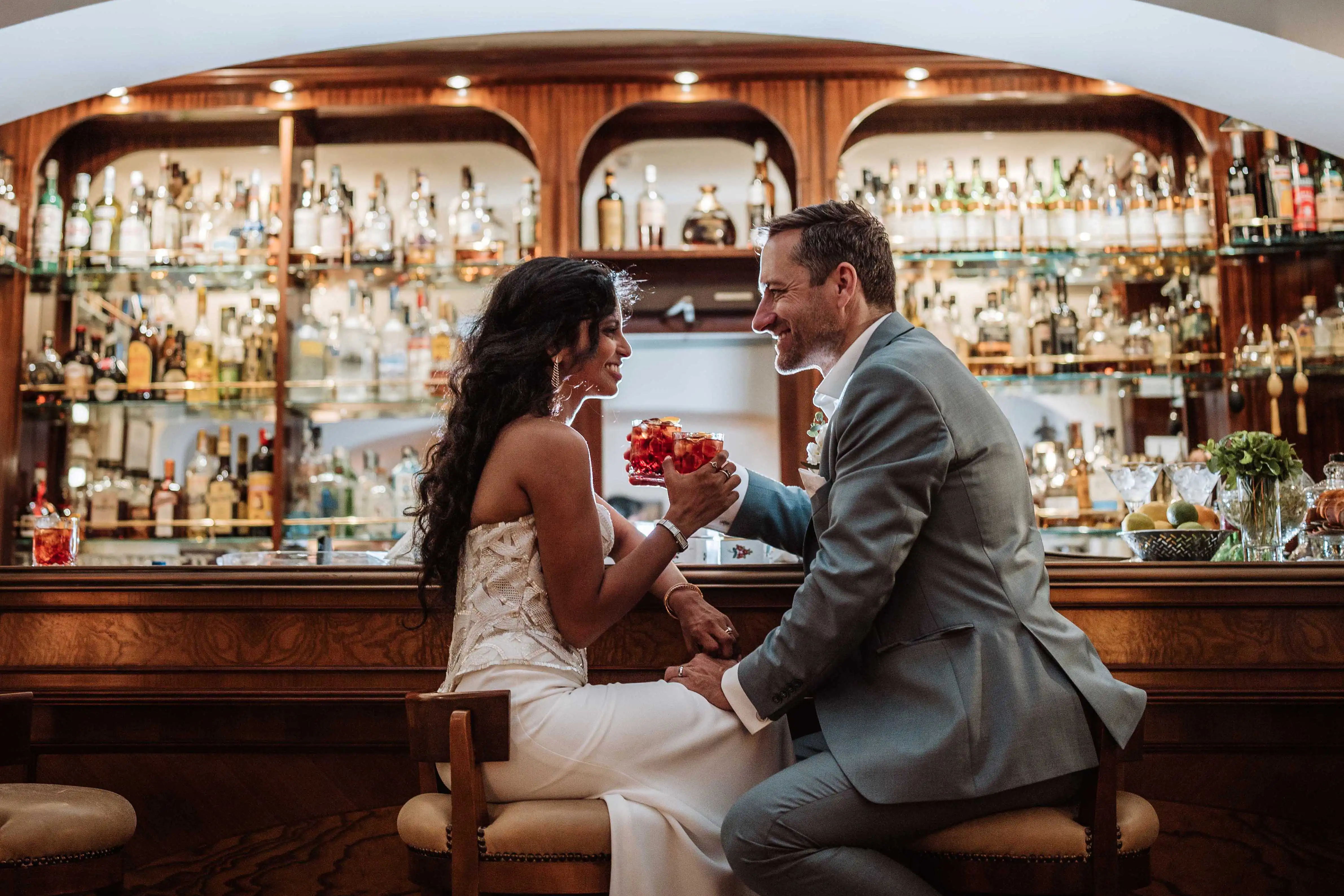 Bride and groom toasting with champagne overlooking Lake Como