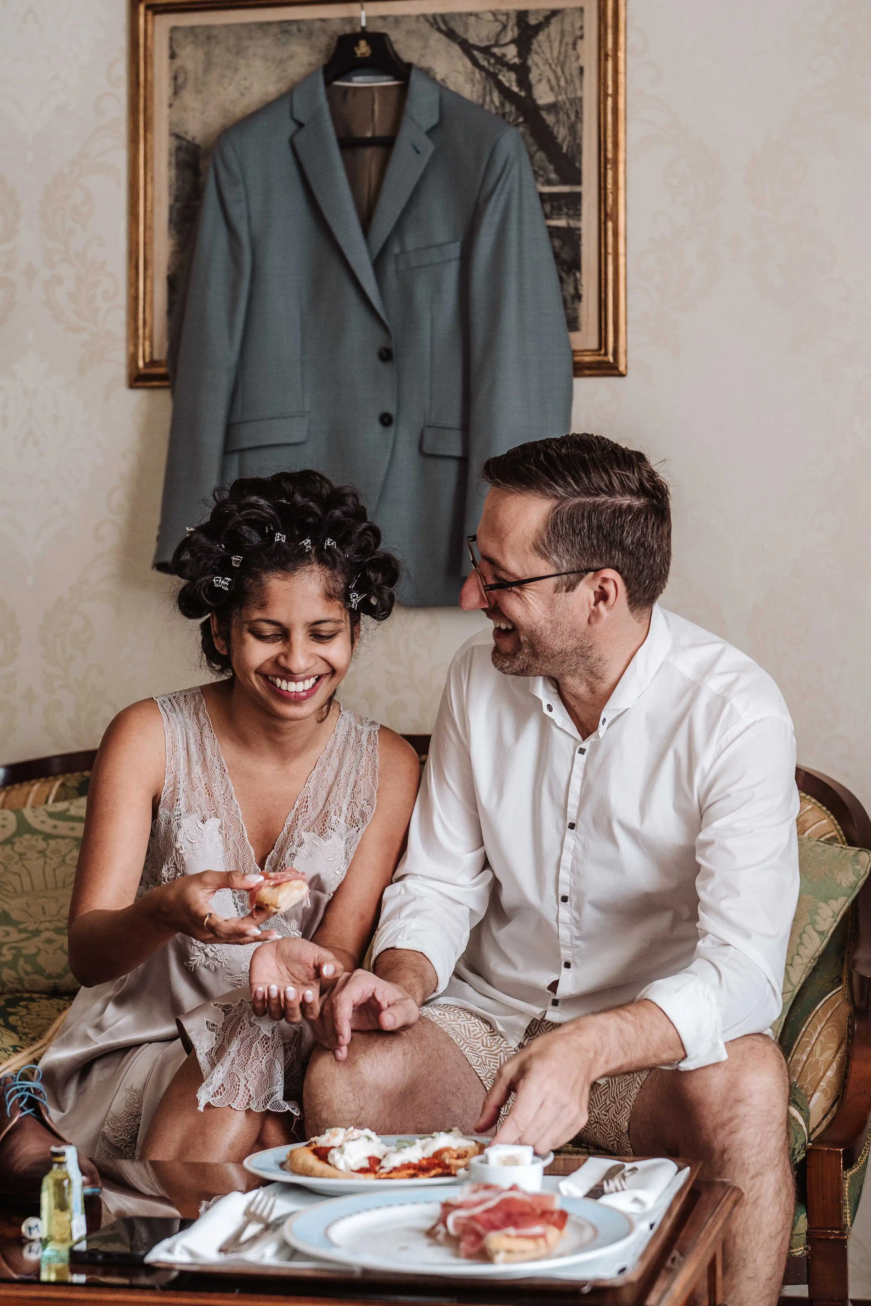 Joyful bride and groom getting ready together in intimate destination wedding in Italy