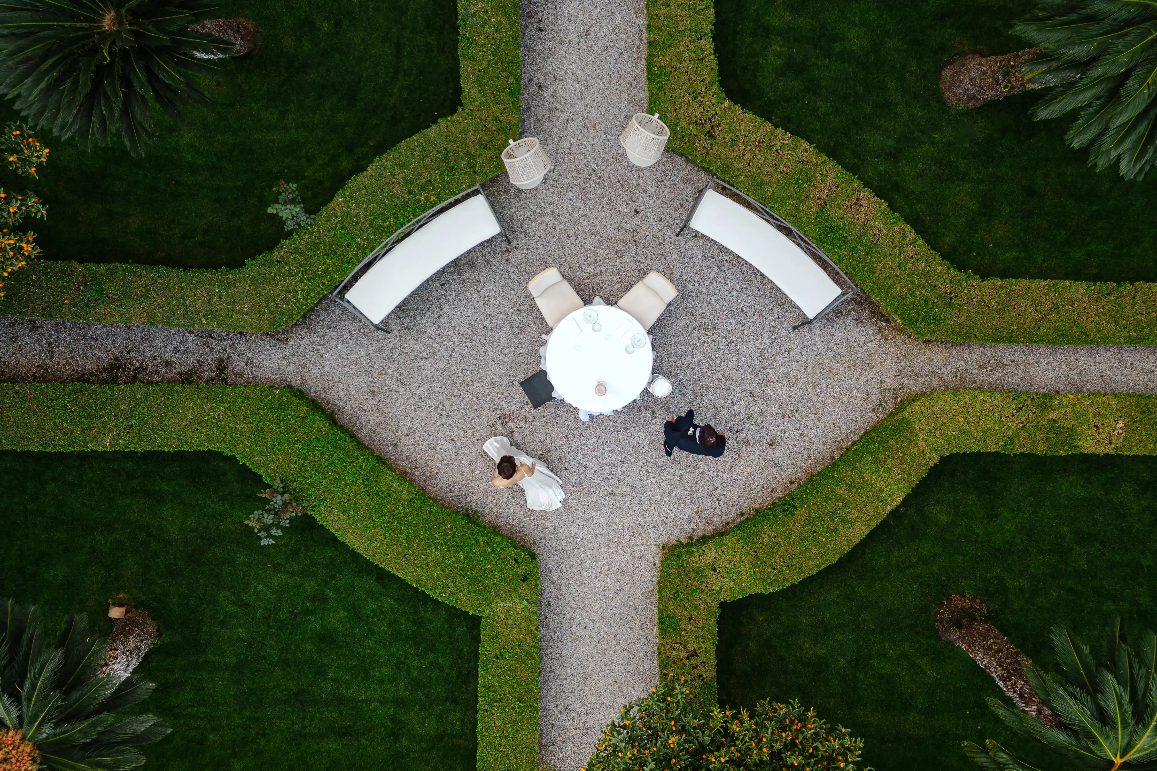 Top view of bride and groom in geometric garden layout in Taormina