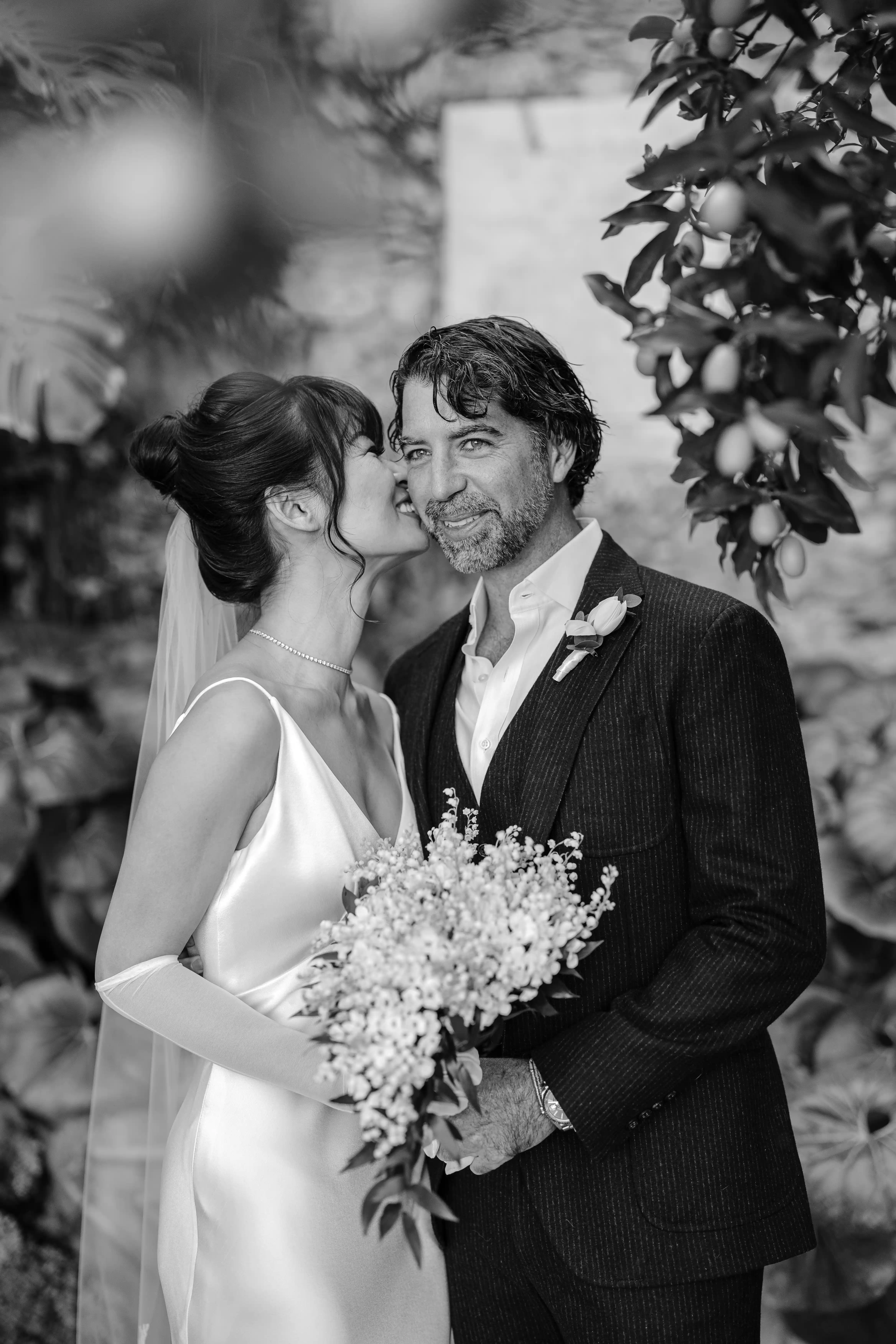 Black and white portrait of couple sharing a candid moment in Sicily