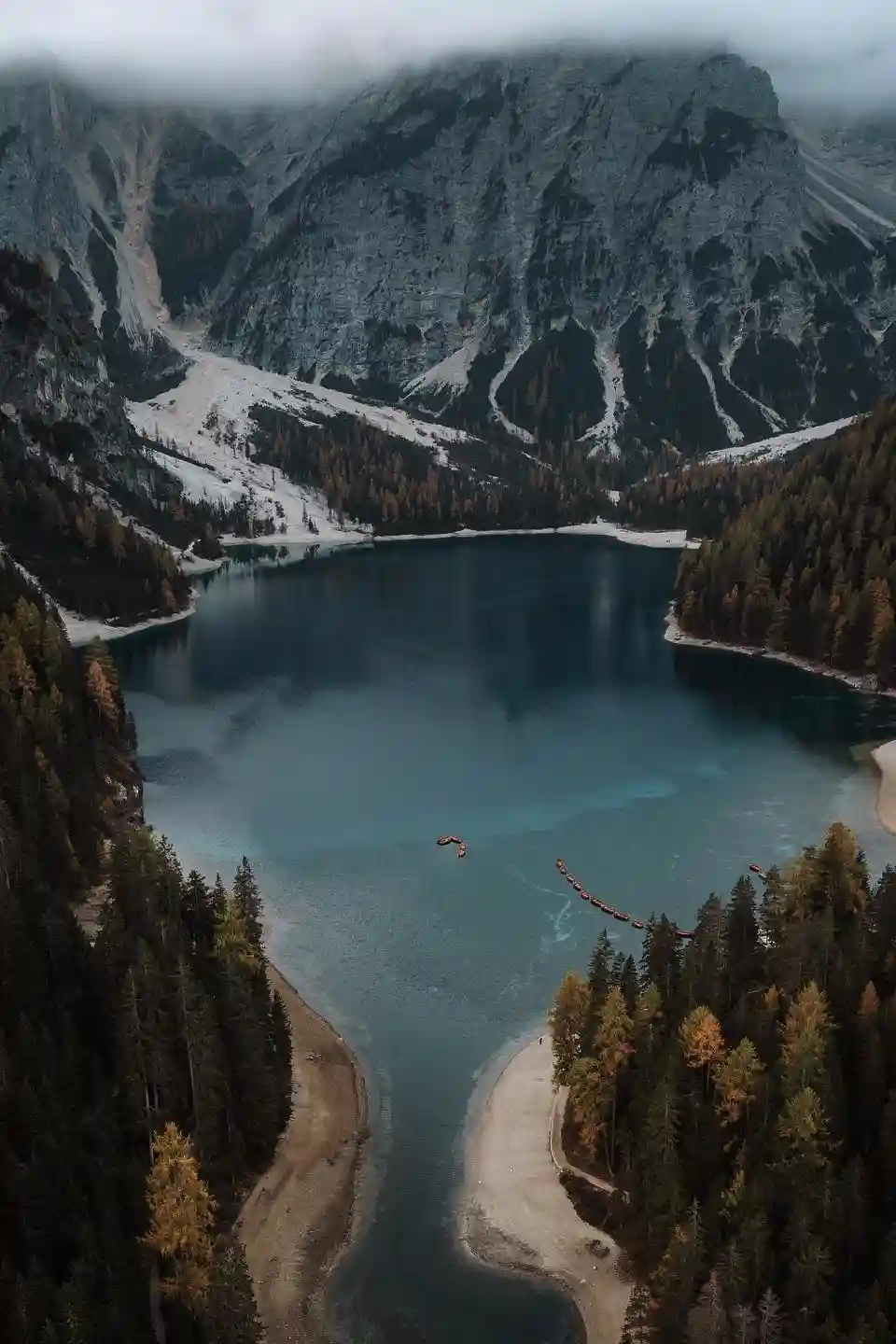 Aerial view of Lake Braies in the Dolomites with turquoise water surrounded by mountains during an elopement