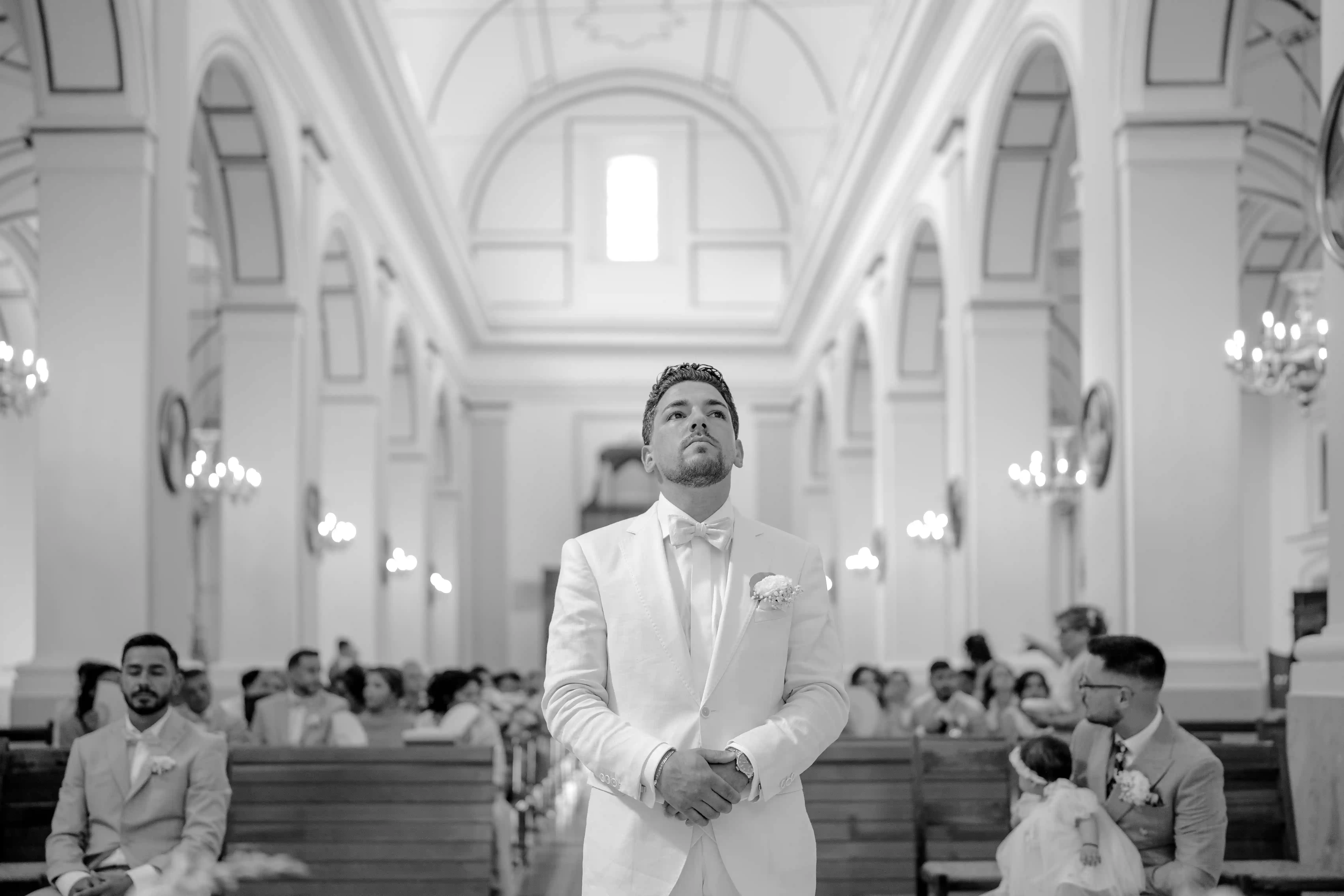 Groom standing at the altar inside a church, waiting for the ceremony to begin