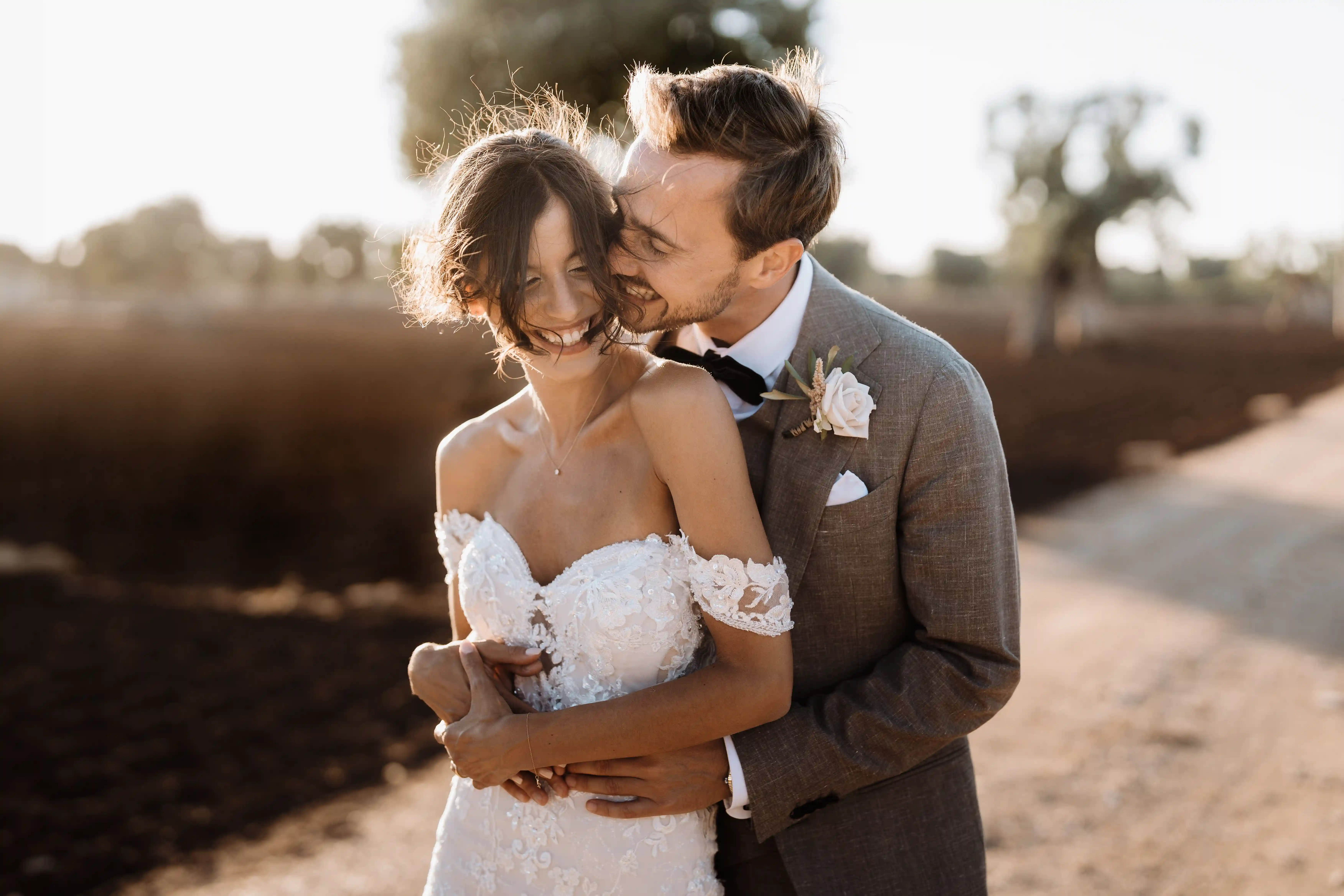Romantic couple portrait at golden hour in Puglia countryside, intimate Italian wedding photography