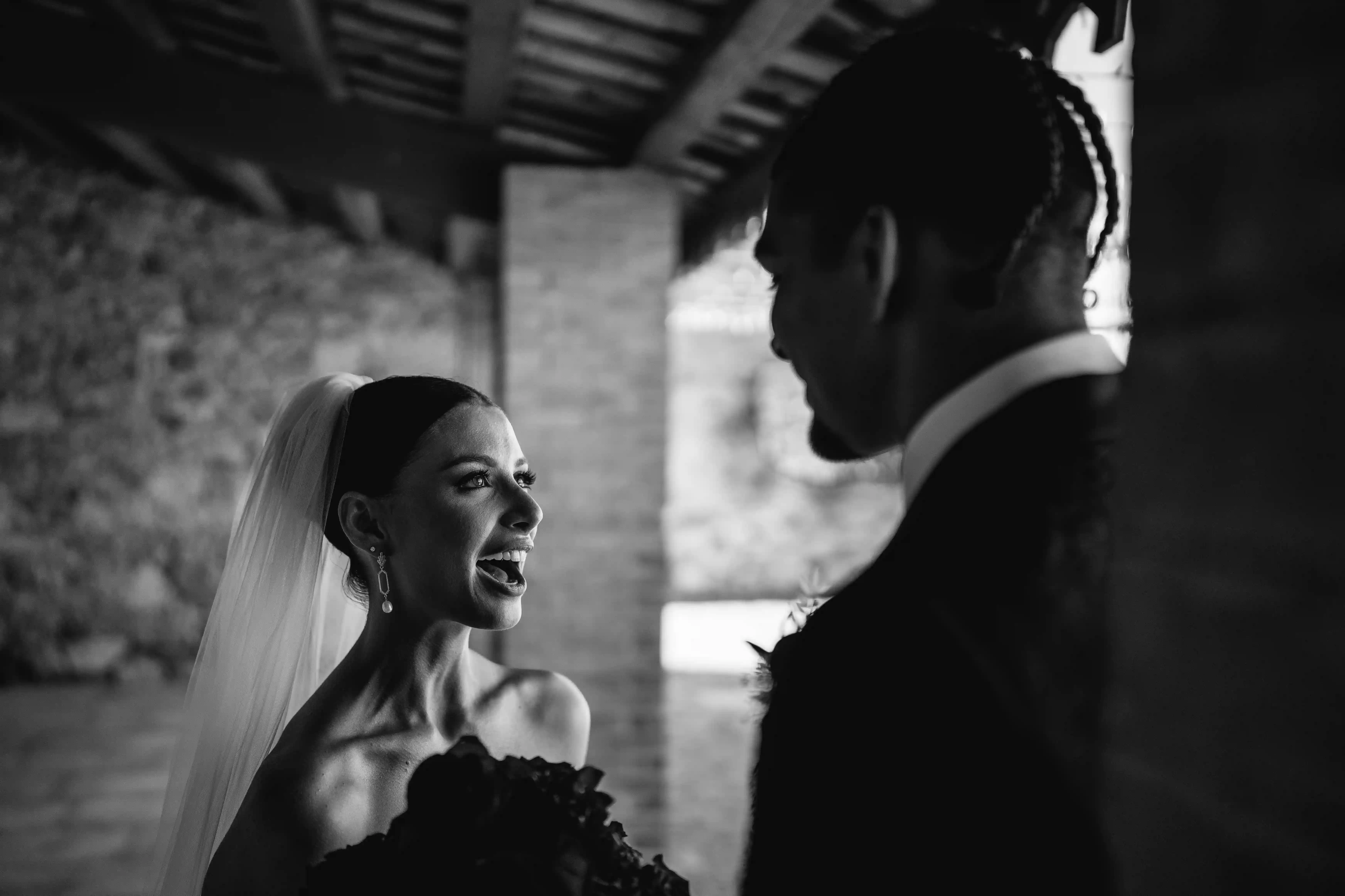 Bride reacting with joy and surprise during an intimate first look moment.
