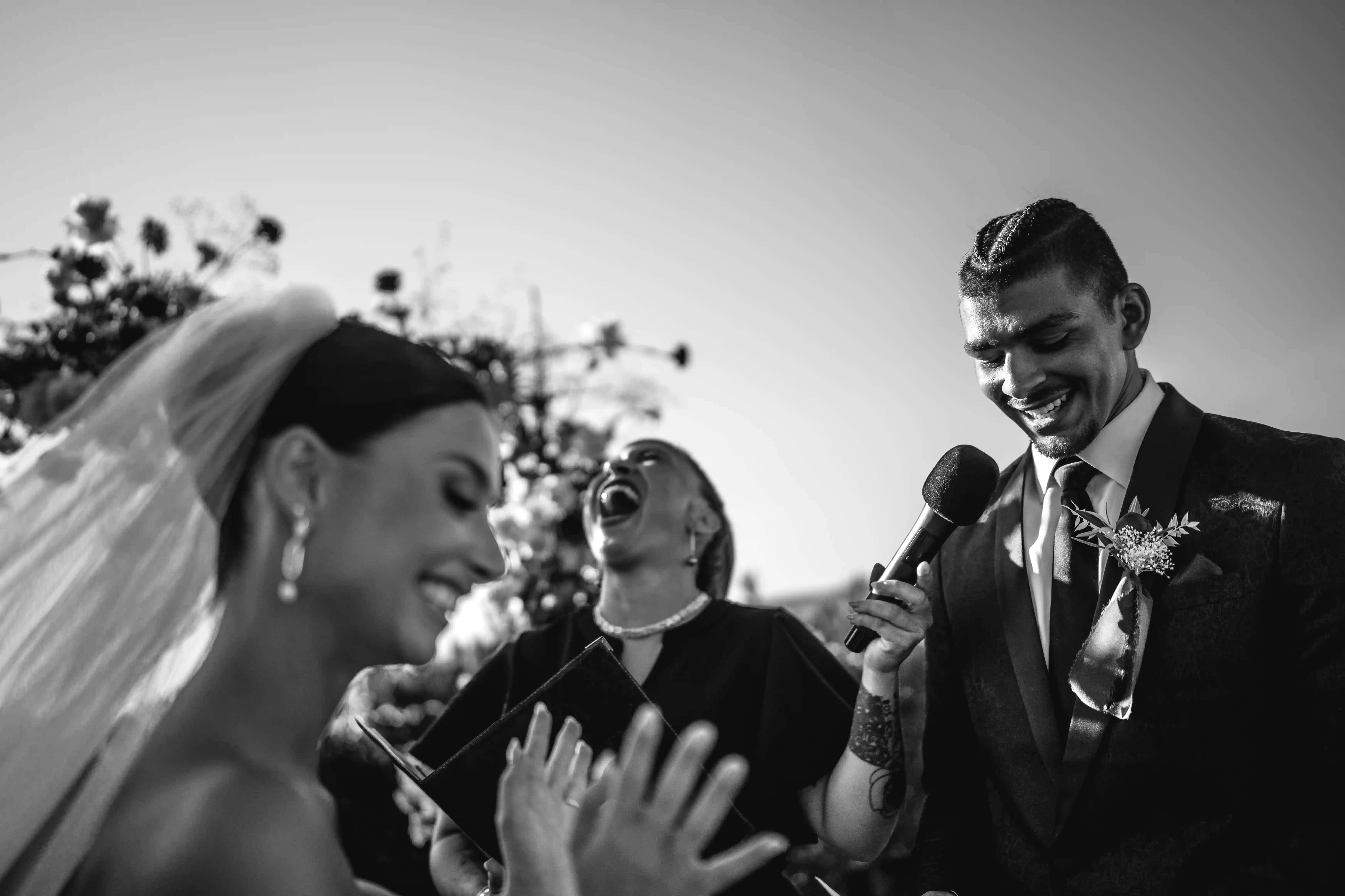 Emotional black and white moment during the wedding ceremony with laughter and heartfelt vows.